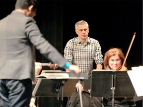 WSO conductor Robert Franz concentrates on the performance of WSO musicians under the guidance of guest conductor Wilbur Lin, left, of Bloomington, Ind. Franz hosted a Conductors Guild Education Workshop at Windsor's Capitol Theatre on Nov. 14, 2017.