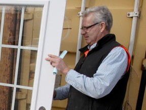 ReStore manager Rick Young checks a selection of exterior doors at Habitat for Humanity's Devon Drive store Friday Nov. 17, 2017.