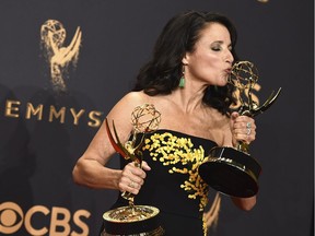 Julia Louis-Dreyfus poses in the press room with her awards for outstanding lead actress in a comedy series and outstanding comedy series for "Veep" at the 69th Primetime Emmy Awards on Sept. 17, 2017, at the Microsoft Theater in Los Angeles.