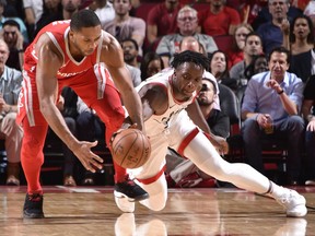 Houston's Eric Gordon, left, and Toronto's OG Anunoby scramble for a loose ball during an NBA game on Nov. 14, 2017, at the Toyota Center in Houston, Texas.