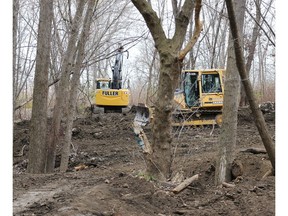 An excavator and a bulldozer level a mountain bike park which was built and maintained by area mountain bike enthusiasts at Little River Corridor Park.