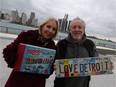 Elaine Weeks and Chris Edwards, pose on the Windsor waterfront with their new published book, called 5000 Ways You Know You're From Detroit, packed with pics and research on the Motor City's baby boomer years.