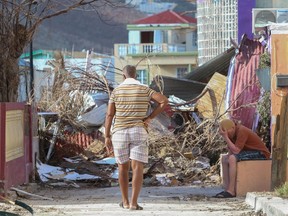 Residents observe the damage left by hurricane Irma on Sept. 11, 2017 in Philipsburg, St. Maarten. The Caribbean island sustained extensive damage from the powerful storm.