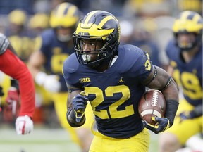 Running back Karan Higdon of the Michigan Wolverines carries for a 49-yard touchdown against the Rutgers Scarlet Knights during the fourth quarter at Michigan Stadium on Oct. 28, 2017 in Ann Arbor, Michigan.
