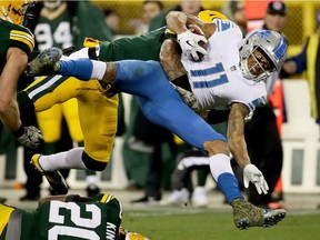 Josh Jones of the Green Bay Packers tackles Marvin Jones Jr. of the Detroit Lions in the fourth quarter at Lambeau Field on Nov. 6, 2017 in Green Bay, Wisconsin.