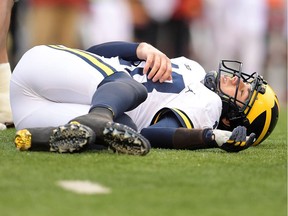 Brandon Peters of the Michigan Wolverines is injured during the third quarter of a game against the Wisconsin Badgers at Camp Randall Stadium on Nov. 18, 2017 in Madison, Wis.