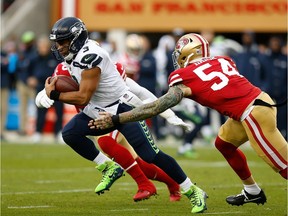 Quarterback Russell Wilson #75 of the Seattle Seahawks runs with the ball against the San Francisco 49ers at Levi's Stadium on November 26, 2017 in Santa Clara, California.