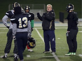 Windsor AKO Fratmen defensive coordinator Mike Morencie instructs the team during a workout at Alumni Field at the University of Windsor on Wednesday.  The Saskatoon Hilltops will meet the Windsor AKO Fratmen in the Canadian Bowl Saturday.  (JASON KRYK/Windsor Star)