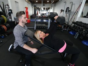 Angela Yakonich and her personal trainer Bradley Bellavance work out during a training session at Brady's Fitness in Tecumseh on Nov. 24, 2017.