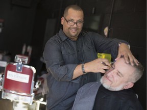 Quinn Jenkins, owner of the Olde Riverside Barbershop, gives Zeljko Petrovic, a client, a shave and cut, Friday, Nov. 24, 2017.
