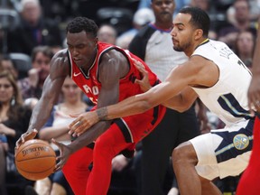 Toronto Raptors forward Pascal Siakam, left, tries to control a loose ball as Denver Nuggets forward Trey Lyles defends in the second half of an NBA basketball game on Nov. 1, 2017, in Denver. Siakam, a big man from Senegal, has been turning heads with his tireless athleticism.