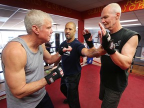 Bob Daragon, left, and Tom Dilworth train with boxing coach Josh Canty, centre, at the Border City Boxing Club on Monday, November 27, 2017. A special boxing training program for individuals with Parkinson's Disease has been established at the gym to help them cope with the illness.