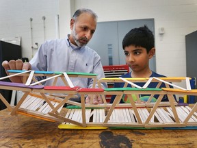 The Professional Engineers Ontario Windsor-Essex Chapter (PEO) held its annual bridge building competition on Nov. 4, 2017, at the University of Windsor. The event was part of PEO's annual "Innovation Station" event series. Young students were encouraged to build a bridge with Popsicle sticks then have it tested for its strength. Asif Khan, chair of the local chapter gives some tips to Zain Malik, 8, after his bridge was tested.