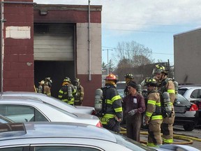 Windsor firefighters attend to a garage fire at 1306 Crawford Ave. - part of N&G Auto Sales & Leasing - on Nov. 24, 2017.