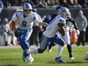 Detroit Lions quarterback Matthew Stafford (9) hands off the ball to running back Ameer Abdullah (21) during the first half of an NFL football game against the Chicago Bears, Nov. 19, 2017, in Chicago.