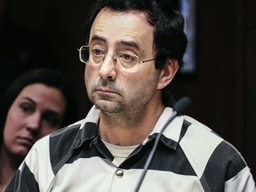 In this Feb. 17, 2017, file photo, Dr. Larry Nassar listens to testimony of a witness during a preliminary hearing, in Lansing, Mich.