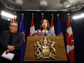 Alberta Justice Minister Kathleen Ganley provides details of the proposed cannabis legislation as Ken Kobly president and CEO, Alberta Chamber of Commerce listens in Edmonton Alta, on Thursday November16, 2017. THE CANADIAN PRESS/Jason Franson