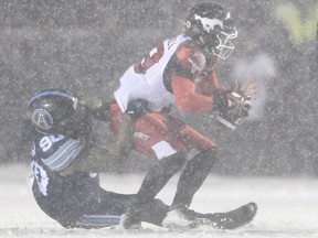 Toronto Argonauts defensive lineman Cleyon Laing (90) sacks Calgary Stampeders quarterback Bo Levi Mitchell during first half CFL football action in the Grey Cup Sunday November 26, 2017 in Ottawa.