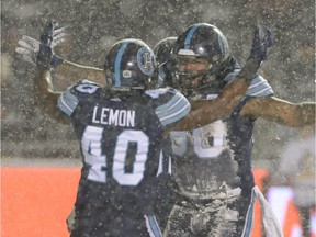 Toronto Argonauts defensive lineman Cleyon Laing (90) celebrates a quarterback sack with defensive lineman Shawn Lemon (40) during first half CFL football action against the Calgary Stampeders in the 105th Grey Cup Sunday November 26, 2017 in Ottawa.