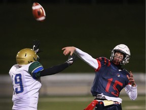 Holy Names quarterback Jake Heydon throws a pass over Jakob Knowles of Sarnia St. Patrick during SWOSSAA AAA football final at Alumni Field on Nov. 22, 2017. Holy Names won 41-7 to advance to OFSAA in Hamilton on Nov. 28, 2017.