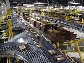 In this Aug. 3, 2017, photo, packages ride on a conveyor system at an Amazon fulfilment centre in Baltimore.