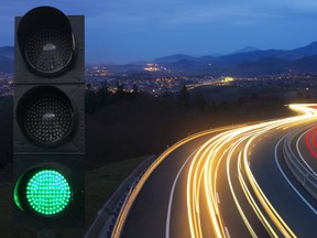 Traffic lights are shown as car lights speed by.