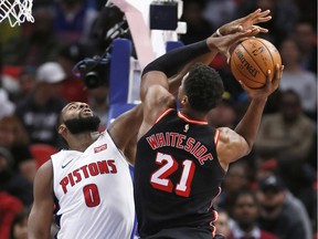 Detroit Pistons’ centre Andre Drummond defends against a shot by Miami Heat centre Hassan Whiteside during the second half of an NBA basketball game on Nov. 12, 2017, in Detroit. The Pistons defeated the Heat 112-103.