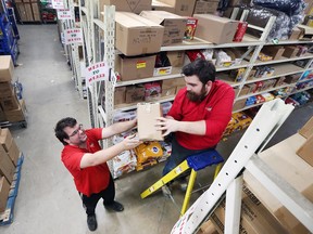Mike Brewer, left, and Brandon Wall are shown at the west Windsor Canadian Tire store on Nov. 1, 2017. They credit a program at the Unemployed Help Centre for landing jobs at the store.