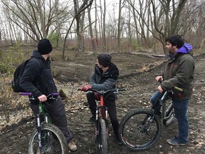 From left: Jonathan Gignac, Nick Drouillard, and Julian Gauthier look back at the demolished bike course in Little River Corridor Park on Nov. 23, 2017.