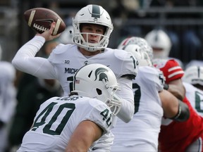 Michigan State quarterback Brian Lewerke throws a pass against Ohio State during the first half of an NCAA college football game Nov. 11, 2017, in Columbus, Ohio.