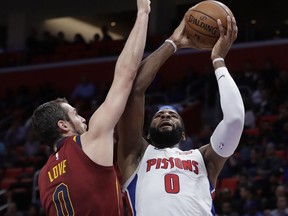 Detroit Pistons center Andre Drummond (0) shoots as Cleveland Cavaliers forward Kevin Love (0) defends during the first half of an NBA basketball game,  Nov. 20, 2017, in Detroit.