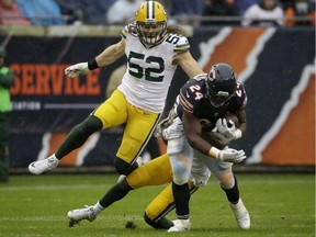 Green Bay Packers free safety Ha Ha Clinton-Dix (21) and outside linebacker Clay Matthews (52) tackle Chicago Bears running back Jordan Howard (24) during the first half of an NFL football game, Nov. 12, 2017, in Chicago.