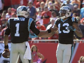 Carolina Panthers wide receiver Kelvin Benjamin, right, celebrates with quarterback Cam Newton after Benjamin caught a 25-yard touchdown pass against the Tampa Bay Buccaneers during the fourth quarter of an NFL game on Oct. 29, 2017, in Tampa, Fla.