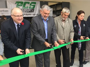 WindsorEssex Economic Development Corporation CEO Stephen MacKenzie, left, PCS president Dave Cataldi, Essex County Warden Tom Bain, and Tecumseh Coun. Tania  Jobin help cut a ribbon on Nov. 2, 2017, to officially open a PCS warehouse in Tecumseh.