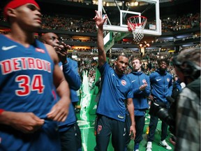 Detroit Pistons' Avery Bradley, centre, acknowledges the crowd during a video tribute before an NBA basketball game against the Boston Celtics in Boston, Monday, Nov. 27, 2017. Bradley, who played seven seasons in Boston before being traded to open cap space for Gordon Hayward, received a standing ovation when a video tribute was played during the pregame introductions.