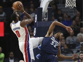 Detroit Pistons centre Andre Drummond shoots the ball after Minnesota Timberwolves centre Karl-Anthony Towns fall back in the first half of an NBA basketball game on Nov. 19, 2017, in Minneapolis.