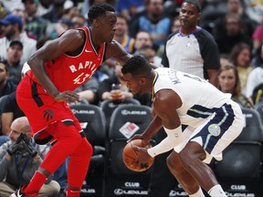 Toronto Raptors forward Pascal Siakam, left, of Cameroon, defends Denver Nuggets forward Paul Millsap as he picks up a loose ball in the first half of an NBA basketball game on Nov. 1, 2017, in Denver.