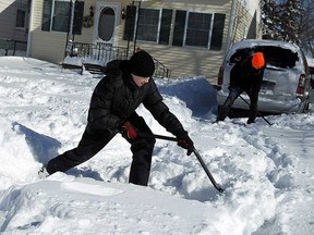 The Rivard family dig out their driveway after heavy snowfall in Windsor in February 2015.