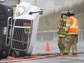 Emergency crews work at the scene of a transport truck that rolled over on the west-bound onramp to Highway 401 from Highway 3 August 17, 2017.  One person was taken to hospital with minor injuries.