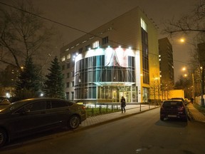 In this photo dated Nov. 9, 2015, a woman walks from the entrance of Russia's National anti-doping agency, RUSADA in Moscow.