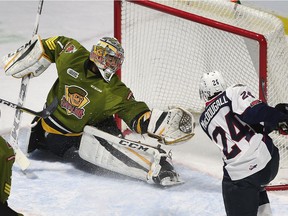 Windsor Spitfires rookie Matthew MacDougall scores the first of his two goals on North Bay Battalion goalie Julian Sime during Thursday's 5-2 win at the WFCU Centre. (DAN JANISSE/The Windsor Star)