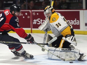 Luke Boka of the Windsor Spitfires gets in close on Sarnia Sting goalie Aidan Hughes during an exhibition game on Sept. 15, 2017, at the WFCU Centre in Windsor.