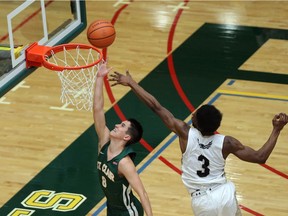 St. Clair College Saints men's basketball player Alex Seguin scores on Conestoga's Sydney Kabongo during the OCAA men's basketball game on Saturday at the SportsPlex. (JASON KRYK/Windsor Star)