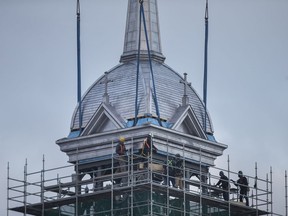 The spire is raised onto the steeple on Ste. Anne's church in Tecumseh on Nov. 14, 2017, after sitting on the ground for 10 years.