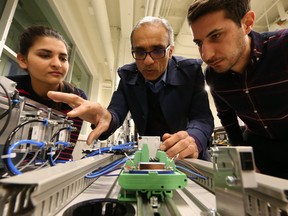 Second year electrical and computer engineering student Gagandeep Saini, left, computer engineering assistant Prof. Shahpour Alirezaee and engineering master's student Saad Pola work in a lab a the University of Windsor on Nov. 7, 2017.