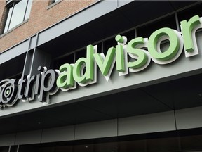 The company logo for the travel website TripAdvisor hangs at the company's headquarters, Nov. 2, 2017, in Needham, Mass. TripAdvisor says it has changed its rules about reviews that contain allegations of rape or other crimes, following a published report that quoted several users who said such postings were deleted.