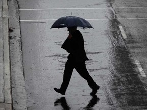 A man carries an umbrella in downtown Windsor on a rainy day in January 2009.