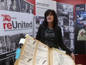 United Way/Centraide Windsor-Essex County chief executive officer Lorraine Goddard displays a scrapbook during preparations for the 70th anniversary celebrations.