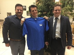 Aaron Kovacs from Bell Canada, left, Amherstburg mayor Aldo DiCarlo and Calvin DeLeavey, also with Bell, pose for a photo Monday night after Bell Canada told town council it is bringing fiber optic Internet to Amherstburg.