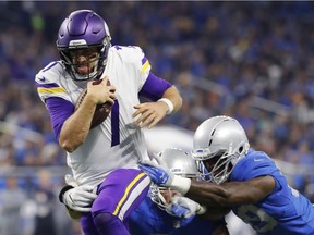 Minnesota Vikings quarterback Case Keenum (7) pulls away from the Detroit Lions defense to score on a 9-yard rush during the first half of an NFL football game on Nov. 23, 2017, in Detroit.